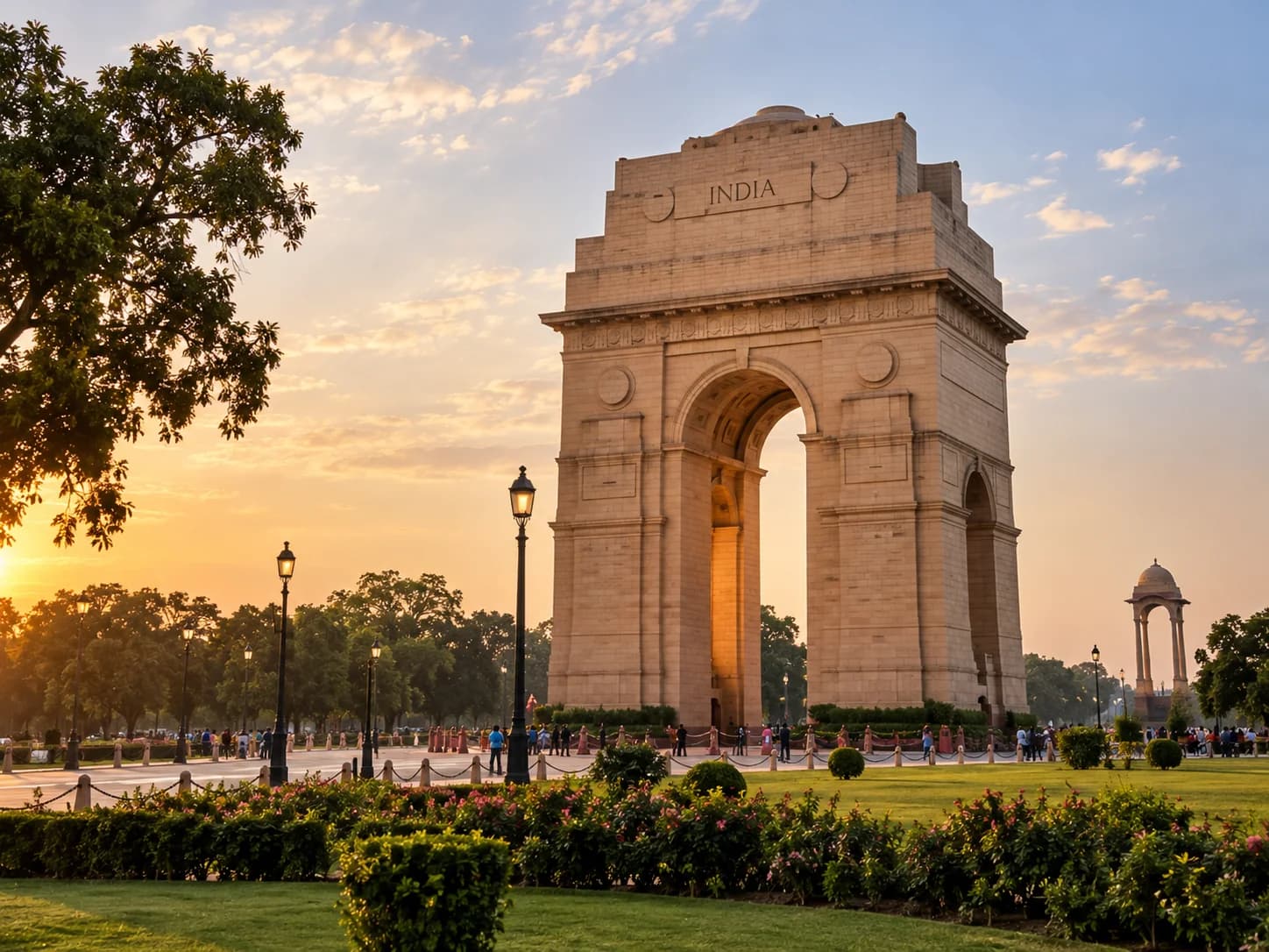 India Gate in New Delhi at sunset, seen across the surrounding lawns